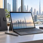 Dell Latitude 7350 accessories including a detachable laptop, USB-C dock, active pen and protective case on a Dubai office desk